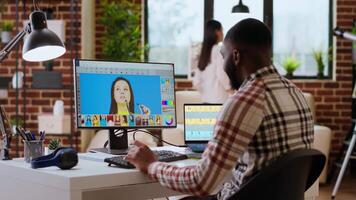 Freelance graphic designer editing photos on a modern computer setup in a remote office. Ideal workspace for a digital design professional, retouching digital pictures from home. Camera B. video