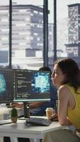 Vertical Employee using AI technology to design algorithms that enable machines to learn from data. Admin in office training large scale deep learning models with artificial intelligence tech, camera B video
