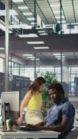 Vertical African american man designing, developing and maintaining software applications using various programming languages. System administrator debugging company servers, preventing failures, camera B video