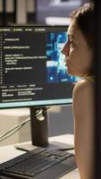 Vertical Employee using AI technology to design algorithms that enable machines to learn from data. Admin in office training large scale deep learning models with artificial intelligence tech, camera A video