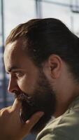 Vertical Pensive employee using computer to analyze datasets, focused on comparing datasets and checking accounting figures. Close up of man concentrating on solving tasks for team project, camera B video