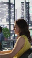 Vertical Admin developing artificial intelligence machine learning APIs solving complex problems. Woman training AI predictive models capable of handling resource intensive tasks, camera B video