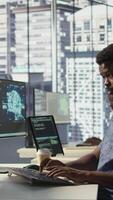 Vertical Manager coming to check on progress done by programmer creating AI machine learning models that can analyze data. Team leader supervising man doing artificial intelligence programming, camera B video