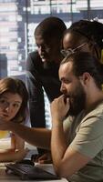 Vertical Programmers gathered together to conduct code review to fix errors, identifying technical issues with company software. Team of developers doing brainstorming, optimizing code, camera A video