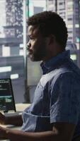 Vertical Data scientist working with machine learning artificial intelligence technology critical to autonomous systems. IT professional working with AI tech to transform data into predictive models, camera B video