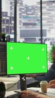 Vertical Man working with machine learning tech on green screen computer, advancing AI innovating autonomous systems, close up. Zoom in on mockup PC monitor used by IT expert in office, camera B video