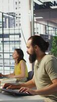 Vertical Annoyed programmer at work raging after losing all progress due to computer crash while creating machine learning models. Angry IT worker smashing desk in frustration while programming, camera B video