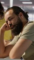 Vertical Exhausted developer caught asleep at desk by manager while developing AI machine learning company tech. Supervisor waking up tired sleeping employee while training predictive models, camera A video