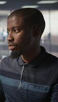 Vertical System administrator doing software quality assurance, checking source code on tablet. Close up of african american IT specialist at work inspecting coding on device, looking to fix errors, camera B video