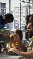 Vertical Team of software engineers doing brainstorming to create machine learning models that can process and analyze data to improve decision making processes. Colleagues working together in office, camera B video