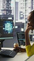 Vertical Staff member in office yawning during shift, feeling tired while looking at artificial intelligence software on PC. Exhausted african american AI company employee being sleepy in workspace, camera B video