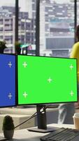 Vertical Employee using multi monitor isolated screen computer to analyze datasets, comparing accounting figures. Woman using chroma key PC to solve tasks for team project, camera B video
