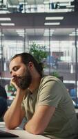 Vertical Fatigued software engineer caught asleep at desk by manager while developing artificial intelligence tech. Team leader waking up lazy worker while training predictive models, camera B video
