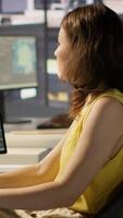 Vertical Admin developing artificial intelligence machine learning APIs solving complex problems. Woman training AI predictive models capable of handling resource intensive tasks, camera A video