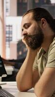 Vertical Fatigued software engineer caught asleep at desk by manager while developing artificial intelligence tech. Team leader waking up lazy worker while training predictive models, camera A video