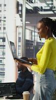 Vertical System administrator creating machine learning models that can process and analyze data to automate decision making processes. IT staff member using laptop to do programming in office, camera B video