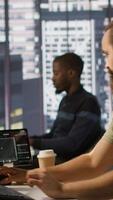 Vertical System administrator checking results on tablet after creating complex machine learning models that can process and analyze vast amounts of data. Admin standing in office, looking at device, camera A video