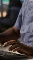 Vertical Man doing data entry, typing on keyboard on PC, solving tasks. Close up of office clerk in workspace making sure documents are compliant with quality assurance expectations and standards, camera A video