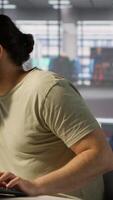 Vertical Annoyed programmer at work raging after losing all progress due to computer crash while creating machine learning models. Angry IT worker smashing desk in frustration while programming, camera A video