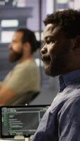 Vertical Programmer waiting for coworker to come help him fix applications issues, dealing with databases and server configuration. IT specialist optimizing company software, assisted by team leader video