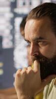 Vertical Pensive employee using computer to analyze datasets, focused on comparing datasets and checking accounting figures. Close up of man concentrating on solving tasks for team project, camera A video