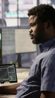 Vertical Developer working together with helpful colleague on artificial intelligence machine learning tech, improving company systems. IT specialist assisted by coworker to compare data video