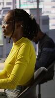 Vertical Computer scientist testing AI company software, identifying errors in machine learning tech. African american IT staff member writing artificial intelligence code in programming language, camera A video