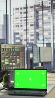 Vertical Focus on chroma key laptop in workspace used by computer scientists doing software debugging. Close up of isolated screen notebook used by workers in office fixing coding issues, camera B video