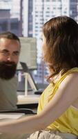 Vertical Cheerful manager in wheelchair doing high five with employee testing machine learning software. Team leader with disability saluting worker, doing friendly gesture, camera A video