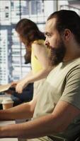 Vertical Portrait of smiling machine learning infrastructure engineer developing algorithms to learn from data. Cheerful man in office training and deploying large scale deep learning models, camera B video