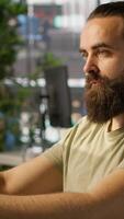 Vertical System administrator with disability in inclusive workspace training machine learning models. IT specialist with paraplegia monitoring and maintaining company systems, camera A video