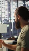 Vertical System administrator checking results on tablet after creating complex machine learning models that can process and analyze vast amounts of data. Admin standing in office, looking at device, camera B video