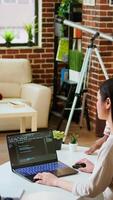 Vertical Diverse software developers team coding on a laptop in a cozy home office, working on a new program or app development. Specialists in IT promote programming language and remote tech work. Camera A. video