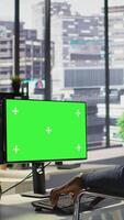 Vertical Developer with disability sitting in wheelchair fixing applications issues on green screen PC. Man with paraplegia optimizing company software with mockup computer, camera B video