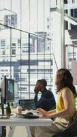 Vertical Manager discussing with employees in office, developing artificial intelligence machine learning APIs. Team leader doing brainstorming with workers, training AI predictive models, camera B video