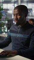 Vertical Portrait of happy programmer working with machine learning artificial intelligence critical to autonomous systems. Upbeat software engineer transforming data into predictive models, camera B video