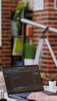 Vertical Asian freelancer woman works on programming code in a modern office at home, using her laptop for computer science. IT specialist supports coding, web development and digital innovation. Camera B. video