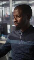 Vertical Upbeat software engineer utilizing cloud computing resources to train and deploy large scale machine learning models. Jolly man monitoring company systems, ensuring their reliability, camera B video