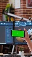Vertical Creative professional uses 3D modeling software to design industrial prototypes, using copy space display. Home office setup showcases innovation, technology and modern tech tools. Camera B. video