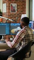 Vertical Engineer designs a turbine in an industrial office using CAD software. Working from home with dual monitors and tools for 3D rendering, boosting productivity and technical precision. Camera A. video
