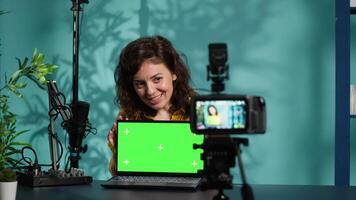 Online show host doing isolated screen laptop unboxing content, filming with professional camera. Tech expert doing chroma key notebook product placement, recording with advanced gear, camera A video