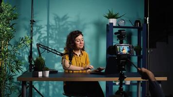 Content creator using production camera gear to film motivational type for fans. Online show host using professional microphone to share inspiring quotes to viewers, camera B video