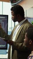 Vertical Coworkers engaging in a problem solving meeting at a corporation, using an interactive board to visualize data and develop solutions for complex challenges. Analysis presentation. Camera B. video