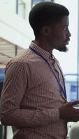 Vertical Team of company analysts reviews feedback on sales and orders to work on improvements, developing marketing and PR strategies in meeting room. Startup enterprise affiliates. Camera A. video