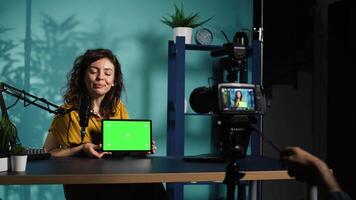 Tech guru excited to review newly released chroma key tablet, comparing features with older models. Influencer filming , analyzing latest generation of green screen digital device, camera B video