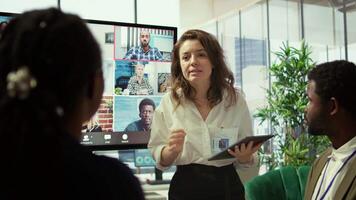 Employees attending an online remote videocall meeting with general manager, presenting project updates for efficiency. Work team ensuring strategic goals achievement in a boardroom. Camera B. video