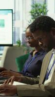 Vertical Shareholder examining infographics and resource allocation on tablet, gathering with associates for a strategy session. Utilizing data analytics to develop innovative solutions for growth. Camera B. video