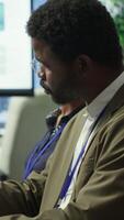 Vertical Shareholder examining infographics and resource allocation on tablet, gathering with associates for a strategy session. Utilizing data analytics to develop innovative solutions for growth. Camera A. video