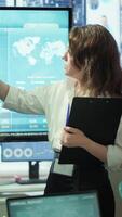 Vertical Corporate associates looking into project details and timetables in conference room, establishing budget and operations to accomplish objectives in a competitive business environment. Camera A. video