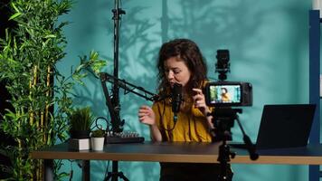 Content creator doing relaxing ASMR type of for fans, recording with professional camera. Online show host using advanced microphone and filming gear to create relaxing , camera A video